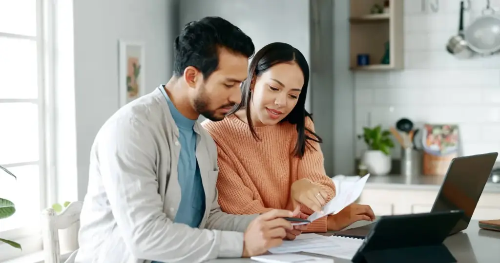 A couple reviewing health results together at a laptop